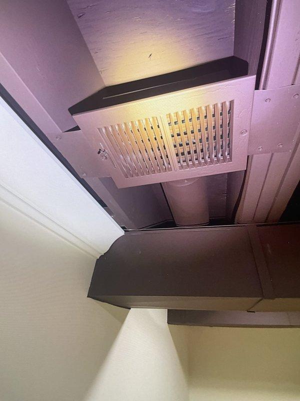 Responded to service call for basement cooling issue with abnormal clinking noise during AC operation. Inspected 3-year-old AC/furnace system and ductwork in basement location. Identified supply duct installation with ceiling-mounted grille and examined ductwork transitions for loose components or debris causing mechanical noise. Verified airflow distribution through supply registers and assessed damper positioning that may have contributed to excessive cooling in basement zone. Documented equipment condition and ductwork configuration with photographic evidence showing ceiling-mounted ventilation components and attic-space duct routing connected to air handler unit.