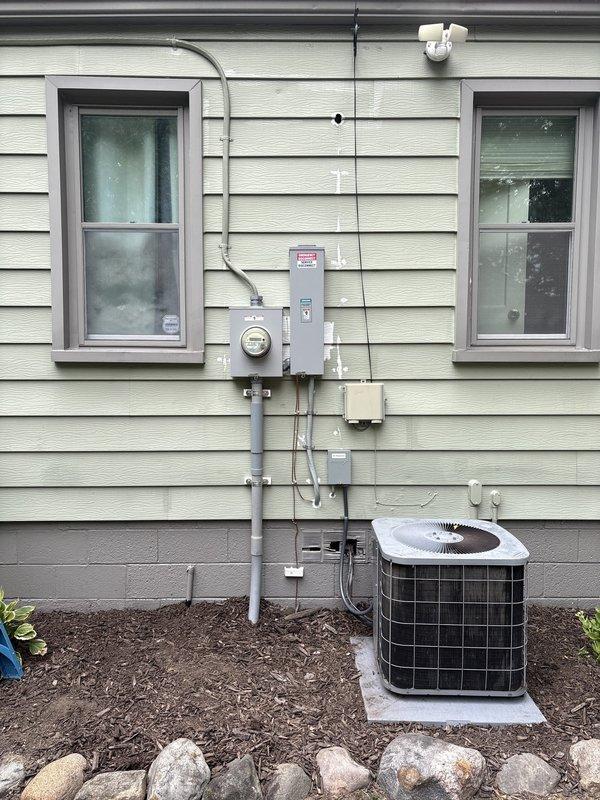 Completed an 8-hour electrical service installation involving exterior meter and service panel work on residential property. Installed new electrical conduit system, meter base, service panel, and associated junction boxes on exterior wall, coordinating with HVAC equipment placement. Interior work included running electrical circuits and installing outlets in unfinished closet space with concrete flooring.