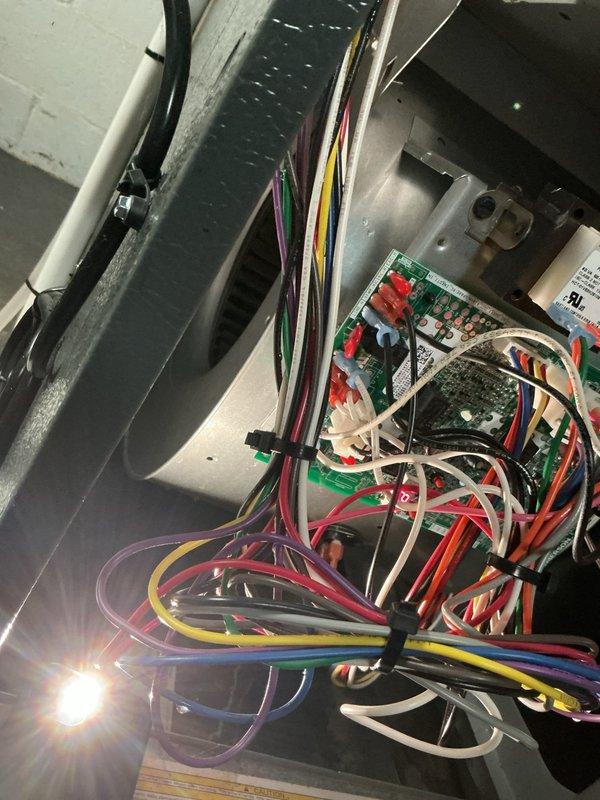 Responded to no-cool complaint on 2-year-old residential air conditioning system with reported freezing condition. Performed diagnostic inspection of indoor air handler unit located in basement and outdoor condensing unit. Accessed control board and internal components to check electrical connections and system operation. Inspected air filter condition and found moderate dust accumulation restricting airflow. Evaluated evaporator coil access area and blower assembly operation. Identified airflow restriction as primary cause of coil freezing issue. Recommended filter replacement and verified proper system operation following service. System restored to normal cooling function with adequate airflow through evaporator coil.