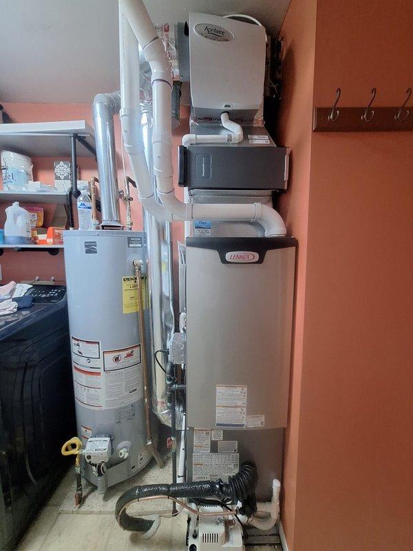 Completed full HVAC system replacement including installation of 70,000 BTU counterflow furnace and 2-ton air conditioning unit in rear configuration. Installed new smart thermostat with programmable scheduling capabilities and integrated iWave air purification system. Added condensate pump to handle drainage requirements for the counterflow application. All mechanical and electrical permits were obtained prior to installation. Reconnected existing electrical service and gas lines to new equipment per code requirements. System was tested and verified operational with thermostat displaying proper cooling mode activation. Installation qualified for utility company energy efficiency rebate program.