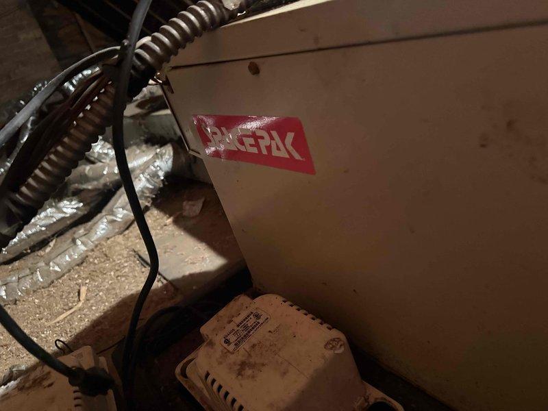 Responded to service call for potential water leak on 10+ year old SpacePack unit located in attic space. Upon inspection, discovered extensive corrosion on evaporator coil assembly and surrounding metal components, indicating prolonged moisture exposure. Heavy rust buildup observed on coil fins and metal framework, with significant oxidation present throughout the unit. The deteriorated condition of the coil and advanced corrosion patterns confirmed active condensate drainage issues contributing to moisture accumulation in the attic space. Documented equipment condition with photographic evidence showing corroded evaporator coil assembly and compromised structural integrity of metal components. Advised customer that evaporator coil replacement would be necessary due to extent of corrosion damage, as the unit's age and deterioration level make repair unfeasible. Recommended full system evaluation to determine most cost-effective solution given equipment age and current condition.