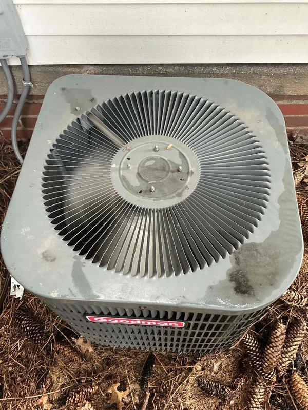 Responded to no-cooling call on 10+ year old Goodman AC unit with non-operational condenser fan. Upon arrival, verified outdoor condenser fan motor was not running despite power to unit. Inspected electrical connections, tested capacitor, and evaluated fan motor for failure. Found fan motor had seized and required replacement. Replaced defective condenser fan motor with OEM equivalent, verified proper rotation and amp draw. Tested system operation through complete cooling cycle. Unit now cooling properly with condenser fan operating within manufacturer specifications.