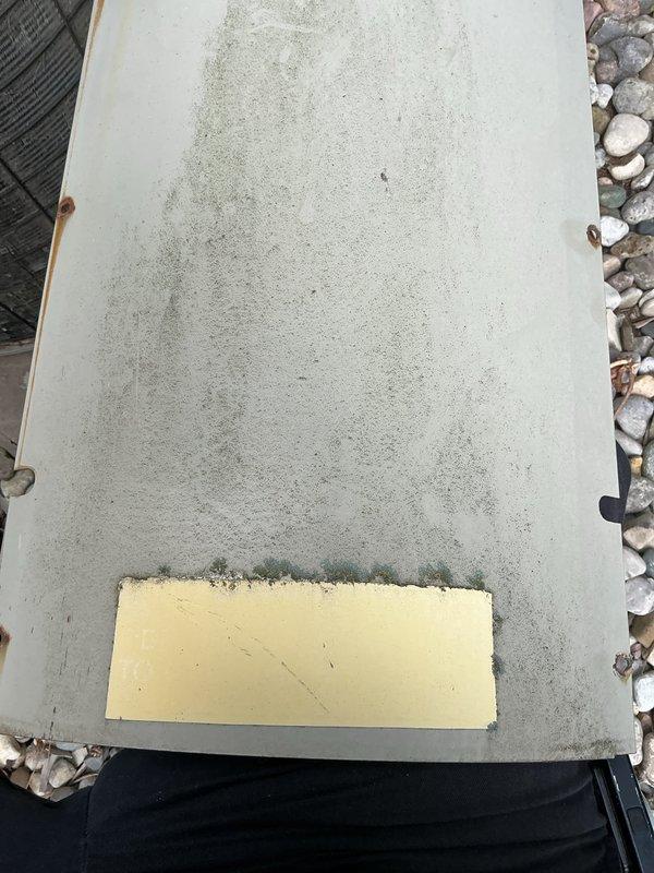 Responded to no-cooling complaint on residential central air conditioning system. Upon arrival, found outdoor condenser unit with significant weathering and age-related deterioration. Inspected dual condenser setup with primary unit showing extensive rust and oxidation on copper-colored top grille, indicating prolonged exposure to elements. Evaluated electrical connections, refrigerant lines, and overall system operation. Documented equipment condition showing compromised components and aging infrastructure requiring attention to restore cooling capacity.