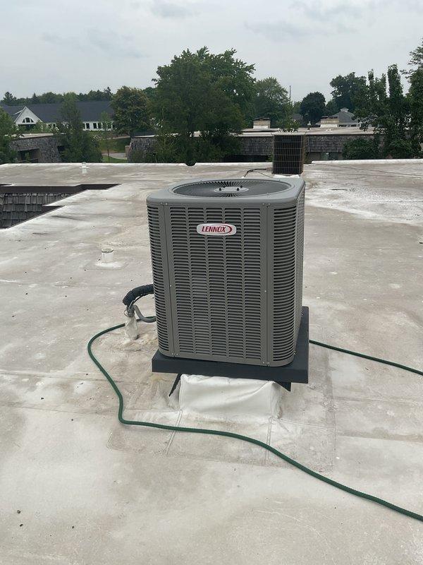 Completed Gold AC Inspection on a 2-year-old Lennox rooftop unit (RTU) installed on a commercial or multi-family building. Performed comprehensive maintenance including visual inspection of unit exterior, verified proper mounting and pad condition, checked refrigerant lines and PVC condensate drainage system, inspected electrical connections and controls including Aprilaire humidistat settings, examined ductwork connections and flexible ducting integrity, tested system operation and airflow, and documented equipment condition with photographic records. Unit found to be operating within normal parameters with all components functioning properly.