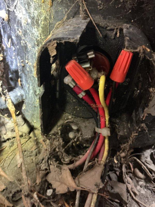 Responded to no cooling complaint on 6-year-old Lennox model 10ACB48-2G7 air conditioning unit located in basement. Upon inspection, discovered severely corroded electrical junction box with deteriorated housing and compromised wire connections using red wire nuts. Extensive rust, moisture damage, and debris accumulation present around electrical enclosure indicated prolonged exposure to adverse environmental conditions. Assessed outdoor condenser unit fan assembly and verified manufacturer specifications. Documented significant corrosion on vertical conduit and junction box requiring immediate attention due to safety concerns and impact on system performance. Electrical connection degradation identified as contributing factor to cooling system failure.