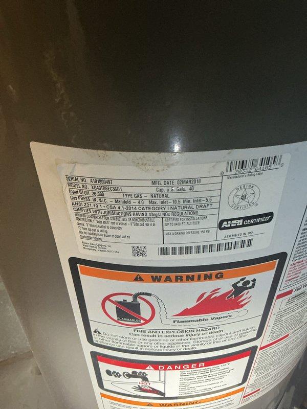 Responded to report of water heater leaking and possible leak from upstairs bathroom. Upon inspection, located a Rheem Performance gas water heater in basement utility area manufactured in March 2018. Conducted thorough visual examination of the unit, including all copper piping connections at top and bottom, gas valve assembly, and tank exterior for signs of moisture or corrosion. Documented existing conditions of water heater installation and surrounding plumbing connections. Assessed potential leak sources and verified unit specifications and safety compliance labels were intact and legible.