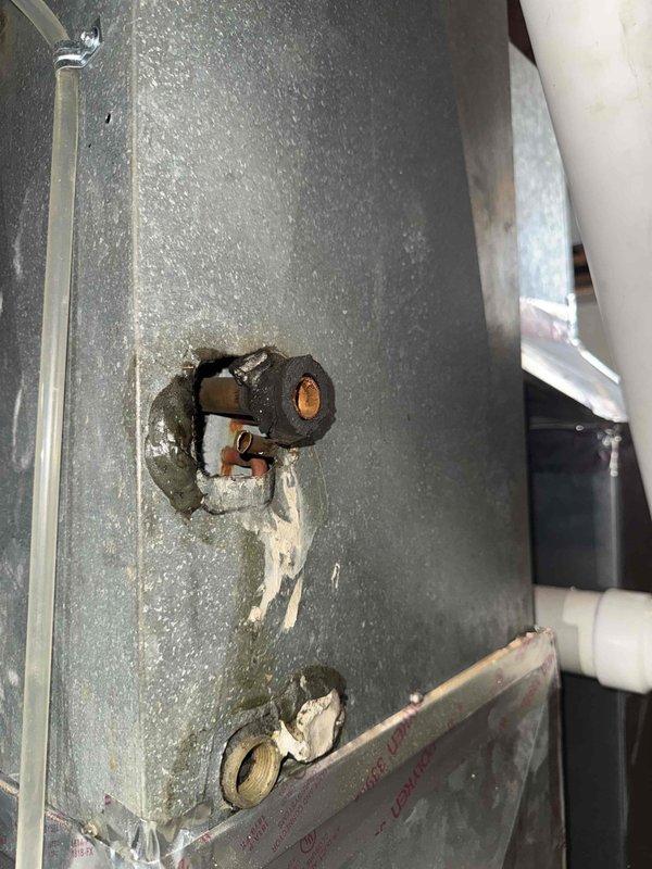 Responded to no-cooling complaint on 16+ year old air conditioning system. Upon inspection, discovered severely corroded and deteriorated copper refrigerant line at outdoor unit penetration point, exhibiting heavy oxidation and surface damage. The compromised refrigerant line is causing system to run continuously without achieving desired temperature due to refrigerant loss. Documented condition of deteriorated copper piping and compromised line set for repair recommendations.