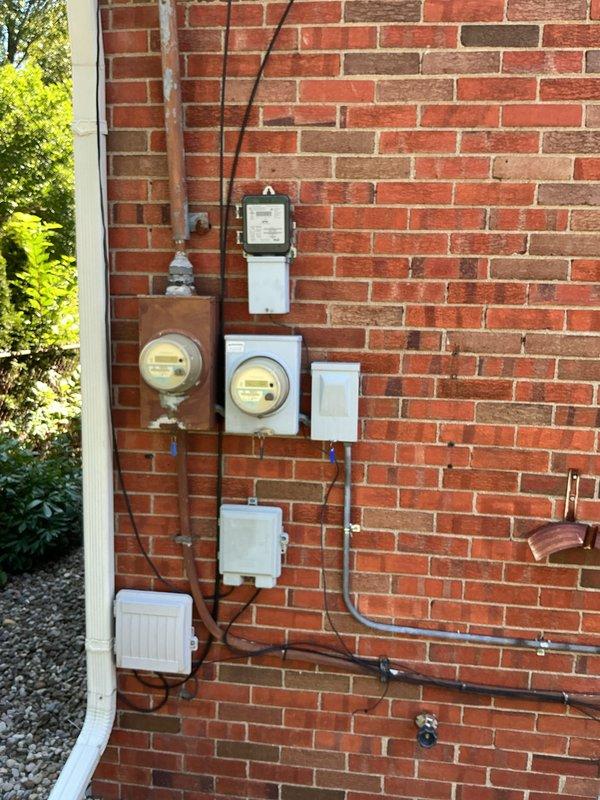 Completed estimate for replacement of 1997 air conditioning system located at exterior of brick building. Assessed existing outdoor condenser unit, electrical service connections including dual meter configuration, and indoor furnace with aluminum ductwork in basement utility area. Provided comprehensive replacement options for aging residential cooling system that has exceeded typical service lifespan, including evaluation of electrical infrastructure, gas line proximity, and ductwork compatibility for new equipment installation.