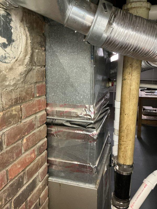 Completed estimate for replacement of 1997 air conditioning system located at exterior of brick building. Assessed existing outdoor condenser unit, electrical service connections including dual meter configuration, and indoor furnace with aluminum ductwork in basement utility area. Provided comprehensive replacement options for aging residential cooling system that has exceeded typical service lifespan, including evaluation of electrical infrastructure, gas line proximity, and ductwork compatibility for new equipment installation.