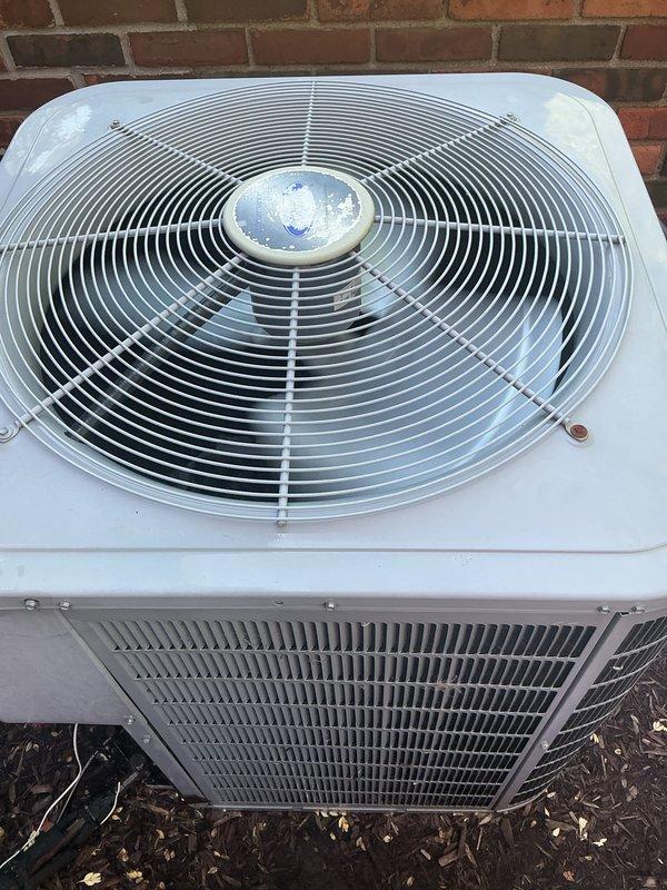 Completed comprehensive cooling system maintenance inspection on three air conditioning units located in utility room, crawl space, and attic. Systems ranged in age from one to five years, with outdoor condensers including Carrier brand equipment positioned on ground-level pads against exterior brick wall. Performed standard preventive maintenance procedures on all three systems, including visual inspection of condenser units, verification of proper airflow through protective grilles and coil fins, and assessment of overall equipment condition. All units found to be in operational status with no immediate repairs required. Exterior condensers showed normal weathering consistent with outdoor installation, with minor debris accumulation around base areas. Protective fan guards and metal casings intact on all outdoor units. Systems cleared for continued operation.