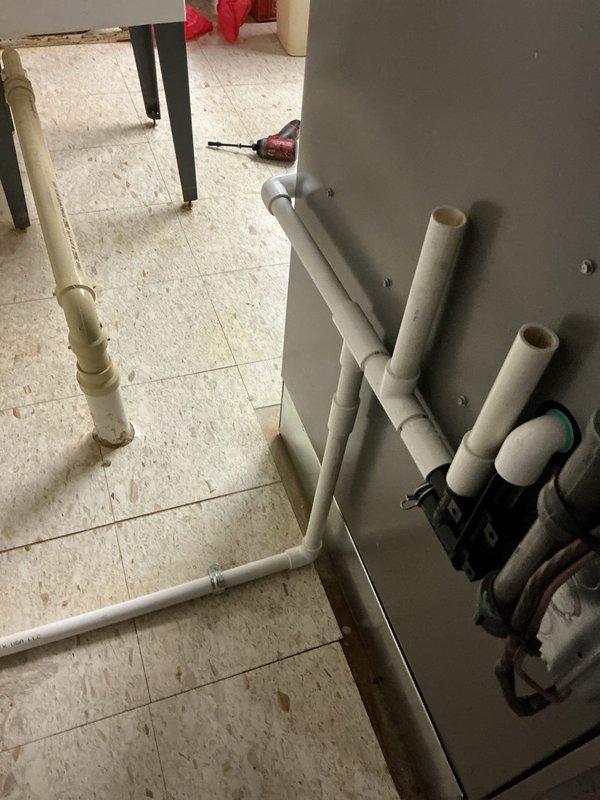 Responded to callback for water leakage issue on less than one-year-old furnace system in basement. Upon inspection, determined evaporator coil orientation was causing improper drainage and interfering with furnace venting. Rotated evaporator coil 180 degrees to correct drain line pitch and ensure proper condensate removal, while also repositioning unit to allow adequate furnace vent clearance. Verified all PVC drain lines and condensate connections were secure and properly sloped. Tested system operation to confirm proper drainage flow and no further water accumulation on basement floor.