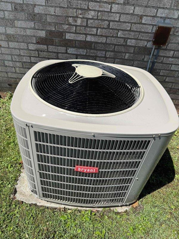 Completed comprehensive Gold AC Inspection on 20-year-old Bryant outdoor condensing unit located at rear of property. Performed full system evaluation including visual inspection of cabinet condition, fan operation, refrigerant line connections, and electrical components. Inspected associated basement air handler and plumbing connections, noting trap primer and shutoff valve installation beneath unit. All equipment found operational at time of inspection with no immediate service needs identified.
