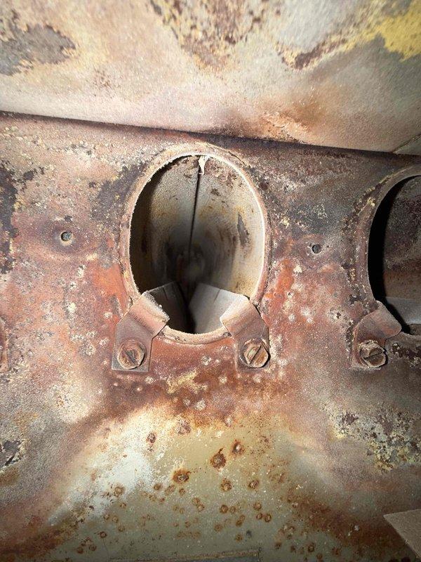 Responded to a no-cooling complaint on an approximately 30-year-old central air conditioning system that had previously received refrigerant charge and fuse replacement from another contractor. Upon arrival, performed comprehensive system evaluation and second-opinion diagnostic assessment of outdoor condensing unit, which exhibited severe external corrosion, rust deterioration throughout cabinet and top panel, and significant neglect with overgrown vegetation obstructing airflow and service access. Inspected condenser fan motor assembly through heavily corroded access port and confirmed previous diagnosis of failed fan motor. Evaluated compressor operation, electrical components, refrigerant lines, and overall system condition. Documented extensive rust damage to cabinet, heat exchanger surfaces, and mounting hardware indicating prolonged exposure to moisture and lack of preventative maintenance. Given the advanced age of equipment, severity of corrosion, and compromised structural in