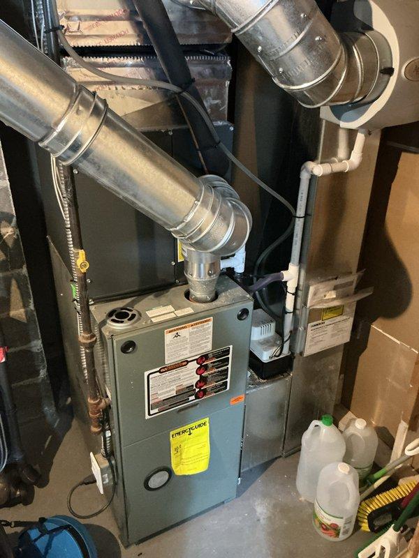 Responded to service call for AC unit not cooling properly with suspected low refrigerant. Upon arrival, inspected 6-year-old Daikin outdoor condensing unit and indoor air handler system. Performed system diagnostics including temperature differential measurements, visual inspection of refrigerant lines, and operational testing. Confirmed unit was operational but running with reduced cooling capacity. Checked electrical connections at outdoor disconnect, inspected condenser coil for debris and airflow restrictions, and verified proper fan operation. Documented equipment condition with photographs of both indoor furnace/air handler assembly and outdoor condensing unit for service records.