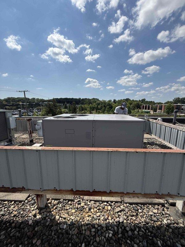 Completed comprehensive inspection of single rooftop AC unit accessed via ladder. Performed visual assessment of RTU components, checked refrigerant lines, electrical connections, and mechanical systems per owner-required certification standards. Documented equipment condition with interior crawl space and exterior rooftop photographs showing unit location, surrounding infrastructure, and accessible service areas. All inspection criteria met and unit found operational within normal parameters.