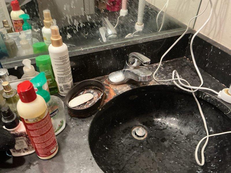 Responded to service call for faucet repair at residential bathroom sink. Upon inspection, assessed single-handle chrome faucet on black granite composite countertop for reported issue. Performed necessary repairs to restore proper faucet operation and functionality. Verified water flow, tested handle operation, and confirmed no leaks present at fixture or supply connections upon completion.