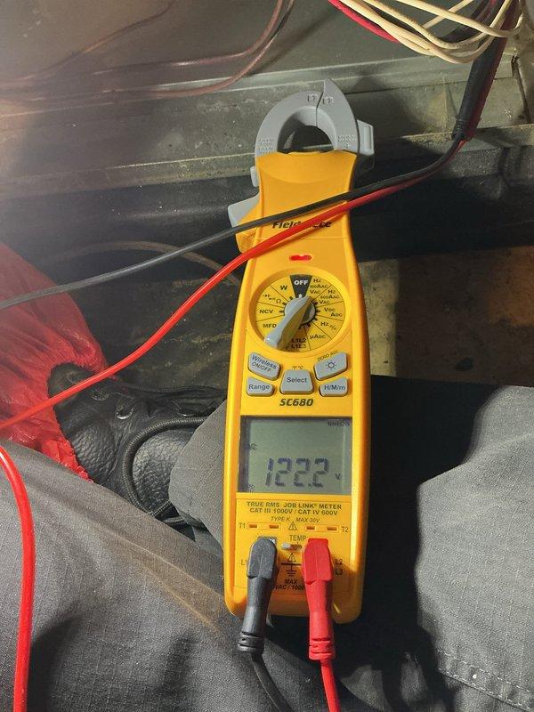 Responded to no cooling call on 5-year-old AC unit located in basement. Upon arrival, confirmed system was completely non-operational with no power to outdoor condensing unit. Performed electrical diagnostics using digital multimeter to test voltage at disconnect and contactor. Measured incoming line voltage at 122V and 552V on separate circuits, indicating power supply issues. Traced electrical fault to failed contactor preventing compressor and condenser fan operation. Replaced defective contactor, verified proper voltage readings across all terminals, and restored power to unit. Cycled system through complete startup sequence, confirmed compressor engagement and proper amperage draw. Tested thermostat communication and verified cooling cycle initiated correctly. System returned to normal operation with adequate airflow and temperature differential.