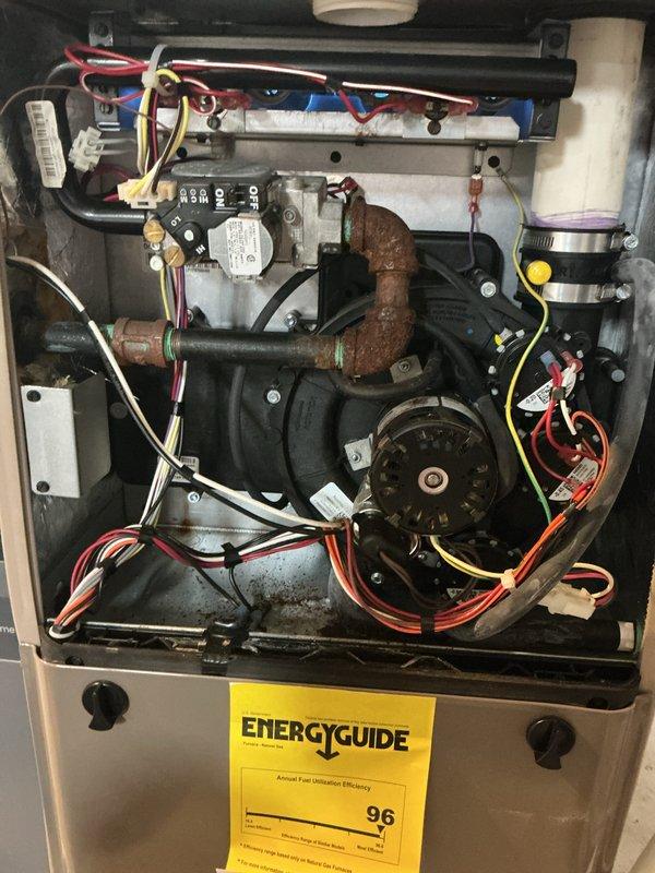 Completed comprehensive Gold AC inspection on 4-year-old residential split system with basement-mounted furnace and evaporator coil, and outdoor condensing unit. Performed thorough visual assessment of outdoor condenser unit, confirming proper fan operation, intact protective grille, and functional electrical disconnect. Inspected indoor furnace and air handler components, noting 96 AFUE-rated unit with accessible blower motor assembly and electrical connections. Observed existing copper refrigerant line showing surface corrosion and rust patina during interior inspection. All major system components including blower motor, gas controls, wiring harnesses, and condensate drainage verified as operational. System confirmed working properly at time of inspection with homeowner present.