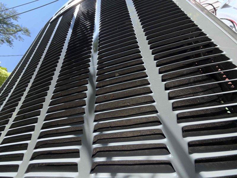 Responded to no cooling complaint on 10-year-old air conditioning system. Upon arrival, confirmed indoor blower motor operating normally but no cold air delivery throughout residence. Outdoor condensing unit running but condenser coils heavily contaminated with dirt, debris, and particulate buildup restricting airflow through fins. Performed thorough coil cleaning to restore proper heat exchange capacity and system efficiency. Unit tested and verified cooling operation restored to normal parameters.