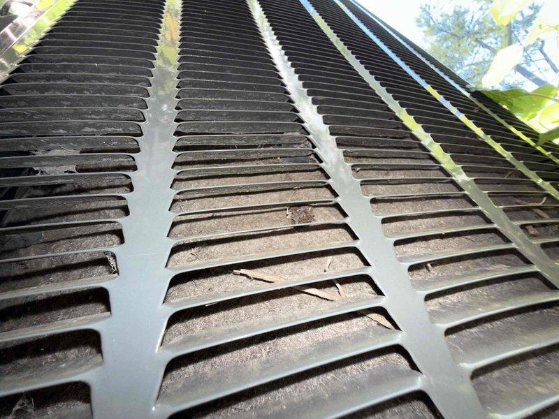 Responded to no cooling complaint on 10-year-old air conditioning system. Upon arrival, confirmed indoor blower motor operating normally but no cold air delivery throughout residence. Outdoor condensing unit running but condenser coils heavily contaminated with dirt, debris, and particulate buildup restricting airflow through fins. Performed thorough coil cleaning to restore proper heat exchange capacity and system efficiency. Unit tested and verified cooling operation restored to normal parameters.