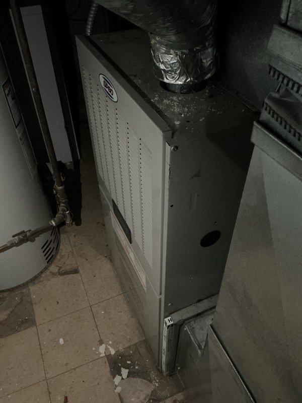Responded to service call for non-cooling air conditioning system. Evaluated 6-year-old A/C unit and air handler located in basement mechanical space. Upon inspection, identified system deficiencies requiring full equipment replacement. Assessed existing air handler with connected refrigerant lines and ductwork, noting debris and maintenance issues in installation area. Reviewed electrical service panel and circuit protection for HVAC system compatibility. Provided comprehensive replacement estimate for new cooling system to restore proper operation and resolve cooling failure.