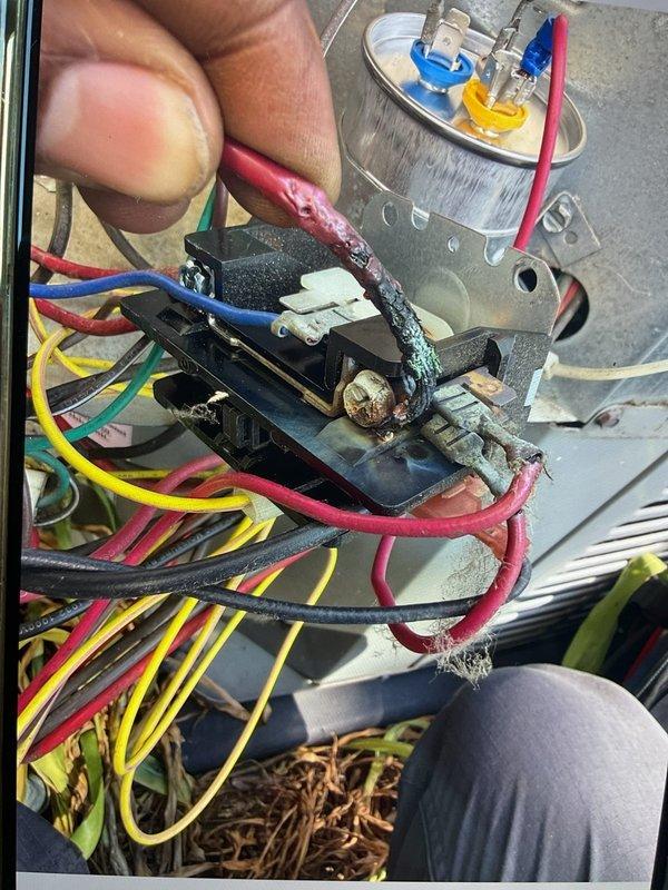 Responded to no cooling complaint on commercial air conditioning unit located in basement. Upon inspection, discovered severely deteriorated electrical terminal block with evidence of thermal damage, corrosion, and melting at wire connections. Red wire connection showed significant heat damage with discoloration on both wire insulation and terminal. White and greenish corrosion deposits were present on multiple metal terminals, indicating prolonged electrical resistance and overheating. Replaced failed Totaline capacitor and damaged terminal block. Cleaned all electrical connections, secured all wire terminations, and verified proper voltage readings. Tested unit operation and confirmed cooling restored to normal parameters.