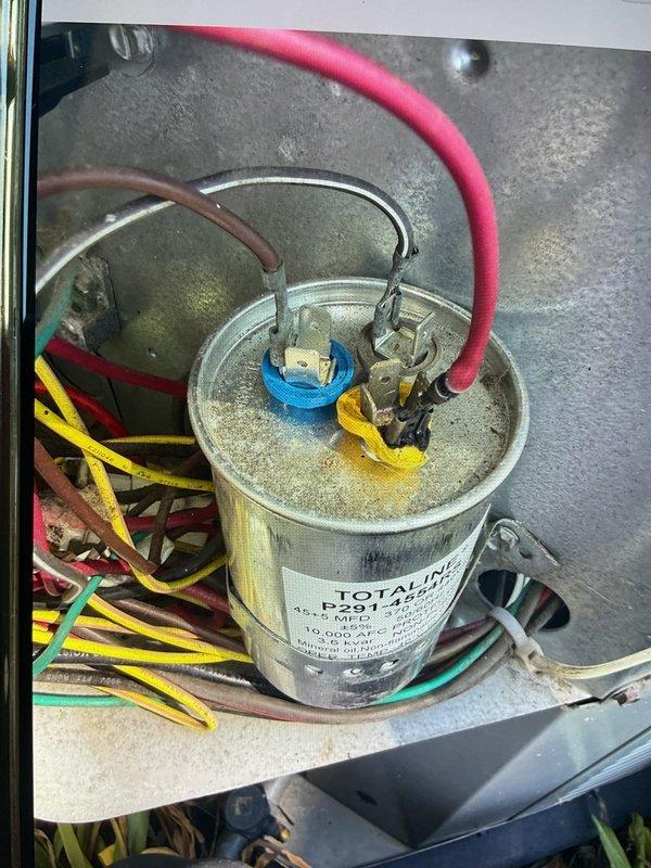 Responded to no cooling complaint on commercial air conditioning unit located in basement. Upon inspection, discovered severely deteriorated electrical terminal block with evidence of thermal damage, corrosion, and melting at wire connections. Red wire connection showed significant heat damage with discoloration on both wire insulation and terminal. White and greenish corrosion deposits were present on multiple metal terminals, indicating prolonged electrical resistance and overheating. Replaced failed Totaline capacitor and damaged terminal block. Cleaned all electrical connections, secured all wire terminations, and verified proper voltage readings. Tested unit operation and confirmed cooling restored to normal parameters.