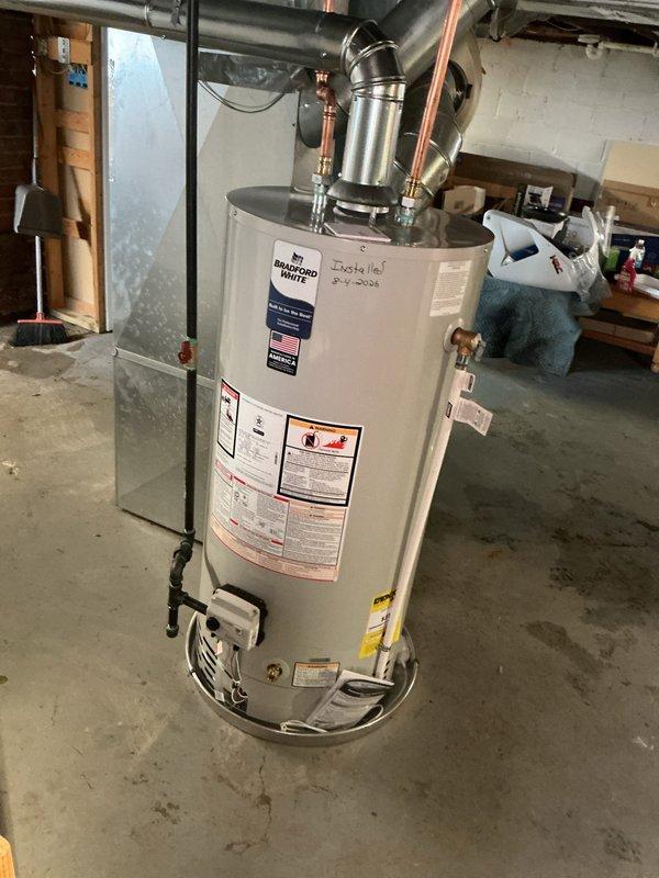 Completed full water heater replacement with Bradford White unit in basement utility area, coordinating with city-scheduled water shut off. Installation included proper reconnection of copper supply lines, pressure relief valve, expansion tank mounting, and all required plumbing connections per code specifications. System tested and verified operational upon completion.