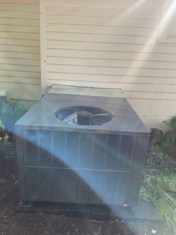 Completed installation of 2-ton packaged rooftop unit (RTU) in rear yard area. Unit installed on prepared concrete pad with proper electrical disconnect and conduit routing along building exterior. All mechanical and electrical connections completed, system tested and operational, with permits requested for mechanical and electrical work per code requirements.