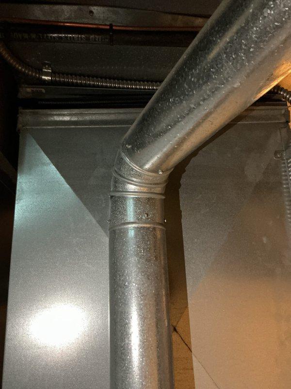 Responded to service call for air conditioning system not providing cold air despite blower and outdoor unit operation. Upon inspection, diagnosed 10-year-old R-22 system with low refrigerant charge. Observed significant condensation on supply ductwork indicating temperature differential issues. Evaluated indoor furnace cabinet and air handler components along with outdoor condensing unit located behind residence. Due to age of equipment, R-22 phase-out, and system condition, provided comprehensive full system replacement estimate for modern high-efficiency HVAC equipment to restore proper cooling function throughout home.