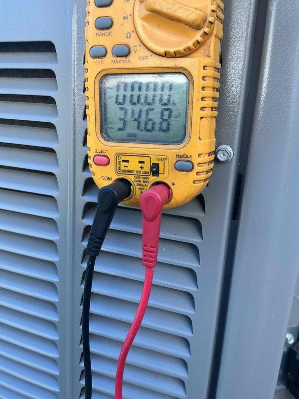 Responded to service call for 2-year-old air conditioning system experiencing loud grinding noise. Inspected outdoor condenser unit in backyard and indoor air handler components in basement. Performed electrical diagnostics using multimeter to verify system voltage and amperage readings. Identified failing condenser fan motor bearing as source of grinding noise. Examined refrigerant line insulation and connections for secondary issues. Unit covered under manufacturer warranty; advised customer of warranty claim process for motor replacement. System temporarily shut down to prevent further damage until replacement part arrives.