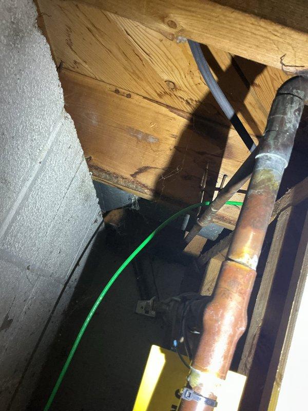 Installed PVB (Pressure Vacuum Breaker) backflow preventer for residential sprinkler system per estimate. The assembly was mounted on exterior brick wall with proper shut-off valves and connection points for garden hose attachment. Interior piping connections were completed in attic space, routing copper supply lines and securing all components to structural beams with appropriate brackets and fasteners to ensure code-compliant backflow prevention for the irrigation system.