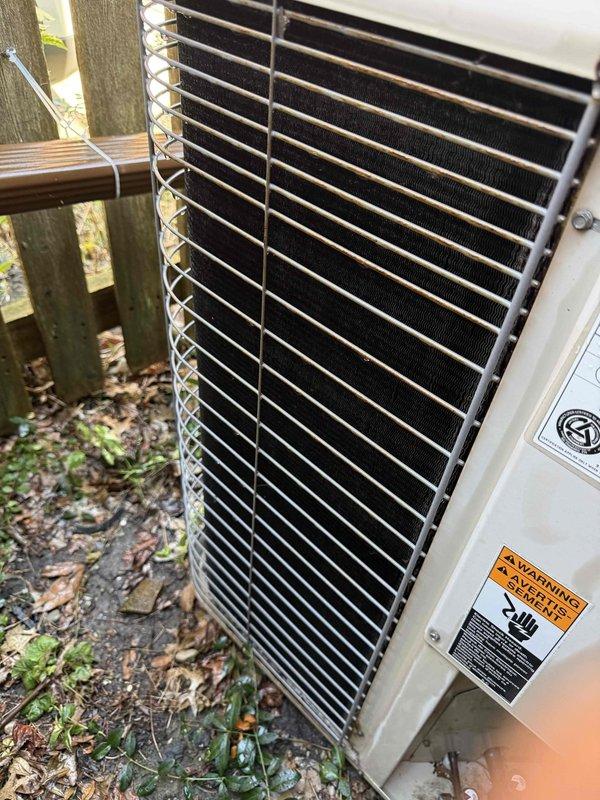 Completed Gold AC inspection on two residential HVAC systems: a 29-year-old unit and a 15-year-old unit, both with air handlers located in the attic. Performed comprehensive multi-point inspection including visual assessment of outdoor condenser unit, which showed standard wear and debris accumulation around the base. Removed and inspected capacitor from one system, which exhibited significant corrosion, discoloration, and rust around terminal connections, indicating component degradation and potential failure risk. Documented equipment condition with photographic evidence showing aged electrical components and exterior unit placement. Advised homeowner of weather-dependent inspection protocols for attic-mounted equipment to ensure accurate system performance evaluation and safety compliance.