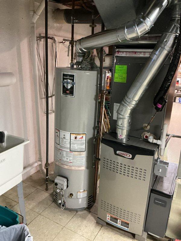 Completed comprehensive Gold AC Inspection on a 2-year-old residential split system with air handler located in basement and condenser unit positioned on exterior concrete pad. Performed full system evaluation including visual inspection of indoor furnace/air handler assembly with refrigerant line connections, ductwork routing, and associated components. Inspected outdoor condenser unit for proper operation, clearance requirements, and overall condition. System found to be in good working order with no immediate service needs identified. All equipment photographed and documented for maintenance records.