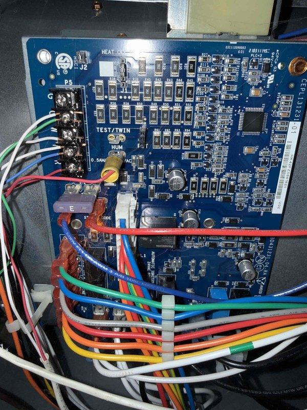 Completed comprehensive Gold AC Inspection on 14+ year old residential air conditioning system with air handler located in basement. Performed full system evaluation including exterior condenser unit inspection, verified proper refrigerant line installation and insulation integrity along exterior brick wall mounting, and confirmed unit positioning on concrete pad with adequate clearance. Inspected indoor control board and electrical connections, verifying all wire terminations at terminal block were secure and properly organized, examined electronic components including capacitors, resistors, and integrated circuits for signs of wear or failure, and confirmed all safety controls and system wiring were functioning within manufacturer specifications. System found operating normally with no immediate service concerns identified at time of inspection.