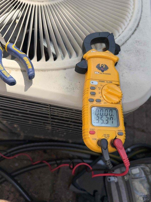 Responded to no cooling complaint on 10+ year old first floor air conditioning system. Upon arrival, performed electrical diagnostics on outdoor condensing unit using clamp meter to measure amperage draw and verify compressor operation. Unit evaluated and electrical measurements recorded to determine system performance and identify cause of cooling failure.