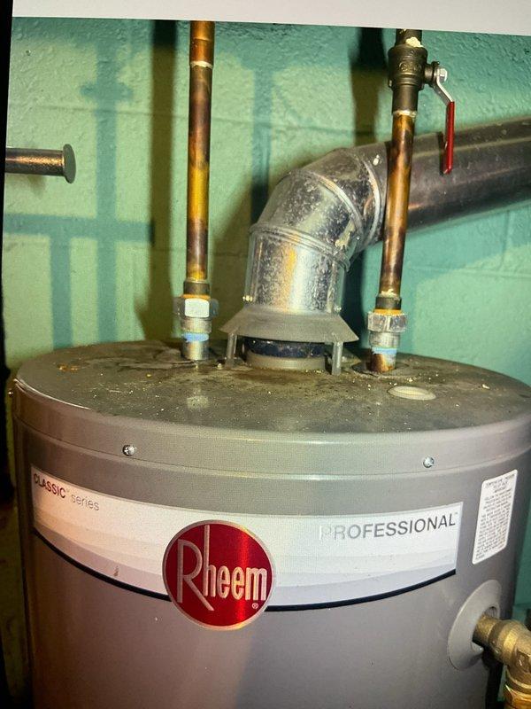 Completed comprehensive Gold AC Inspection on 4-year-old system with air handler located in basement. Performed full multi-point inspection including refrigerant levels, electrical connections, condensate drainage, and airflow measurements. Inspected Aprilaire humidity control system and noted accumulated dust on unit, indicating need for routine cleaning. Observed Rheem Professional Series water heater in mechanical room with dust accumulation on top of tank and copper piping connections. Advised homeowner that replacement air filters are needed for optimal system performance and efficiency.