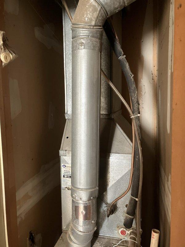 Completed estimate for replacement of 23-year-old R22 cooling system and furnace located on first floor after air conditioning failure. Assessed existing HVAC installation including vertical ductwork, gas lines, and thermostat controls, documenting equipment condition and configuration for full system replacement proposal.