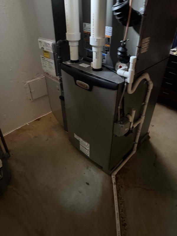Returned to address refrigerant leak on copper elbow fitting of 7-month-old AC system located in basement. Upon inspection, discovered significant corrosion and active leak at curved copper refrigerant line with brass compression fitting, evidenced by moisture accumulation and rust deterioration on pipe surface. System was experiencing short cycling due to low refrigerant charge from leak, resulting in excessive compressor operation and increased energy consumption. Repaired leak at elbow connection, pressure tested system, evacuated lines, and recharged unit to manufacturer specifications. Verified proper system operation with normal run cycles restored.