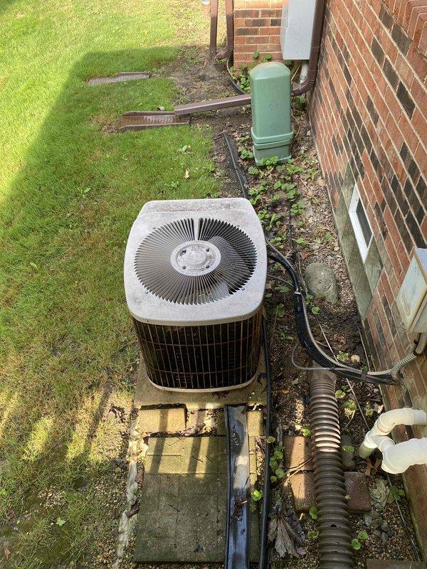 Performed comprehensive assessment of 30-year-old residential HVAC system for replacement estimate. Evaluated existing air conditioning condenser unit located at rear of property and gas furnace with air handler in basement, both original equipment showing age-appropriate wear but currently operational. Documented equipment specifications, measured existing ductwork configuration including metal and PVC components, assessed electrical service and refrigerant line routing, photographed current installation for replacement planning, and provided homeowner with equipment options and system replacement recommendations for aging residential comfort system.