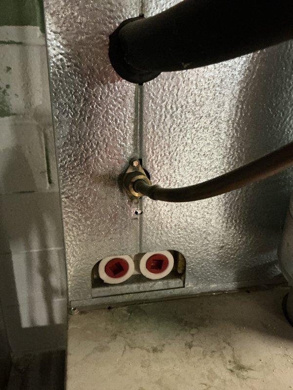 Responded to no-cooling complaint on residential air conditioning system with outdoor condenser unit in backyard and air handler in basement. Upon inspection, verified thermostat was set to OFF mode with indoor temperature reading 78°F. Checked refrigerant line connections at basement air handler penetration point and confirmed proper installation of suction and liquid lines with intact insulation. Instructed homeowner on proper thermostat operation and system controls. System operational upon departure with no mechanical defects identified.