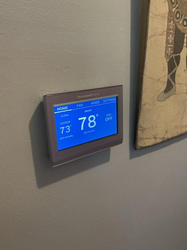 Responded to no-cooling complaint on residential air conditioning system with outdoor condenser unit in backyard and air handler in basement. Upon inspection, verified thermostat was set to OFF mode with indoor temperature reading 78°F. Checked refrigerant line connections at basement air handler penetration point and confirmed proper installation of suction and liquid lines with intact insulation. Instructed homeowner on proper thermostat operation and system controls. System operational upon departure with no mechanical defects identified.