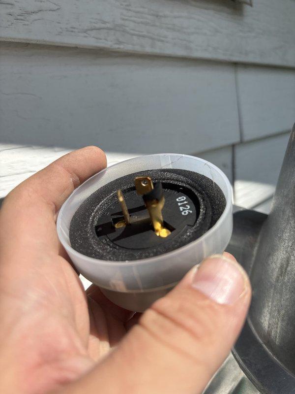 Replaced defective photocell sensor on exterior lighting fixture. Removed old photocell unit from weathered cylindrical fixture housing and installed new replacement component with proper electrical connections to restore automatic dusk-to-dawn operation.
