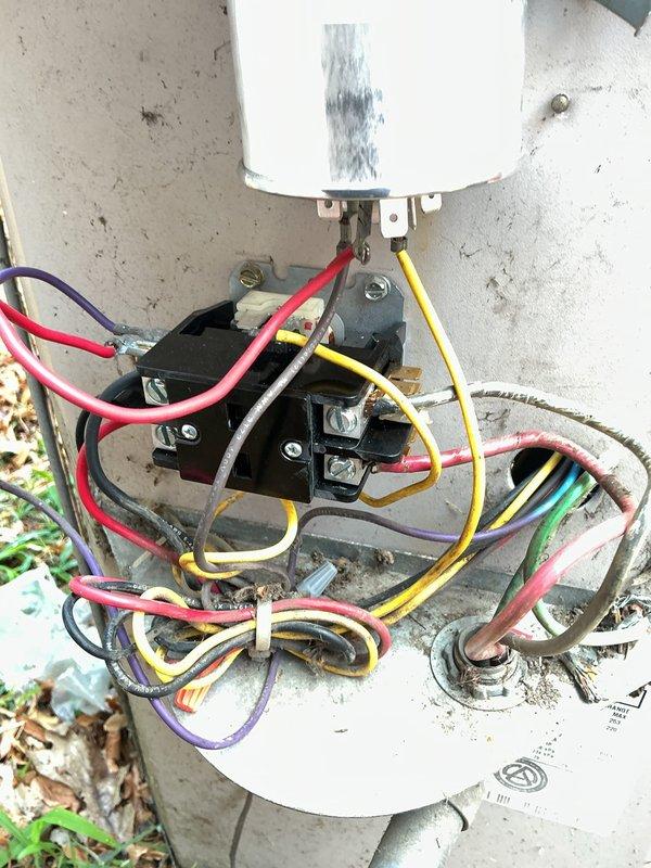 Responded to callback for non-operational first-floor heating and cooling system with outdoor unit fan failure. Upon inspection, found failed contactor with visible heat discoloration on dual run capacitor and corroded electrical connections. Replaced defective contactor, tested capacitor under load showing weak readings, and replaced dual run capacitor. Cleaned and tightened all electrical terminations, verified proper voltage and amperage across all connections. System restored to full operation with outdoor fan running and unit cycling properly.