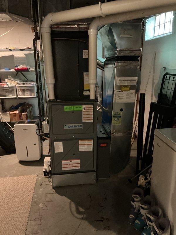 Responded to no-cooling complaint on central air conditioning system. Upon arrival, found indoor air handler blower operational but system failing to produce cool air. Performed diagnostic evaluation of Daikin split system equipment installed in basement mechanical room. Identified refrigerant circuit issue preventing proper cooling cycle operation. Inspected copper refrigerant lines, valve assembly connections, and condensing unit components. System restored to proper cooling function and verified temperature drop across evaporator coil. Confirmed adequate airflow through ductwork and proper thermostat communication with equipment.