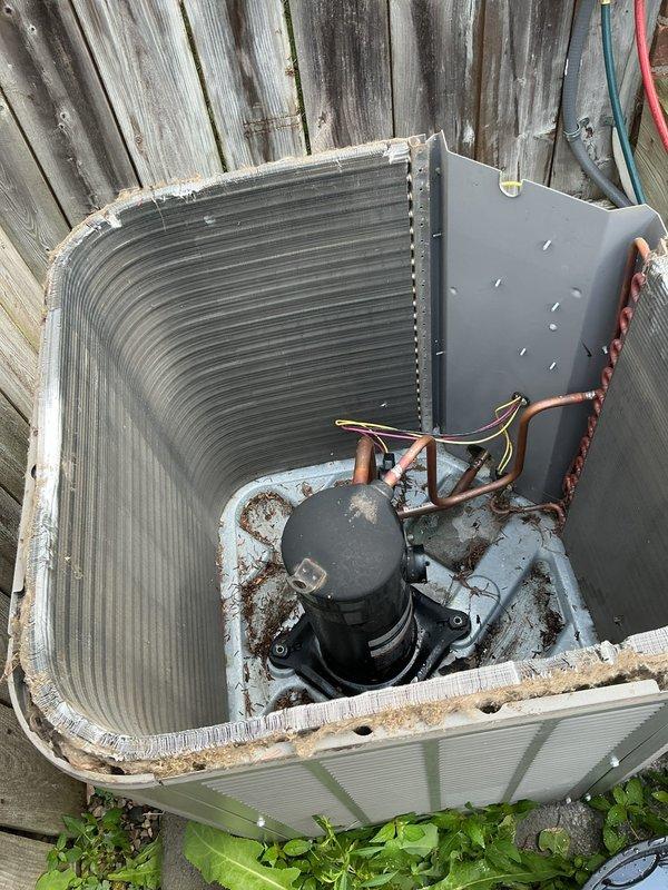 Replaced failed compressor on residential outdoor condensing unit located in side yard between fences. Unit was accessed, top cover removed, and defective compressor was replaced with warranty part. Refrigerant lines were properly connected to new compressor, electrical connections were secured, and system was reassembled. Labor-only repair completed as compressor component was covered under existing parts warranty.