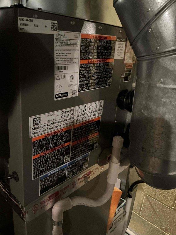 Successfully completed installation of a 2-ton Lennox air conditioning system including outdoor condenser unit and indoor evaporator coil. The outdoor condenser was positioned in the rear yard on a concrete pad against the brick exterior wall with proper clearances maintained for airflow and serviceability. The indoor air handler was installed with appropriate refrigerant line connections, condensate drainage via PVC piping, and electrical connections completed per manufacturer specifications and local code requirements. System was charged, tested, and verified operational with all safety labels and documentation properly affixed.