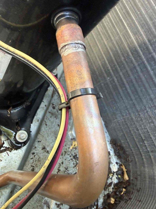 Supervisor returned to locate refrigerant leak in A/C system. Inspection revealed significant corrosion and oxidation on copper refrigerant lines with visible surface deterioration and mineral deposits at connection points. Documented corroded piping components and deteriorated fittings with photographic evidence for further assessment and repair recommendations.