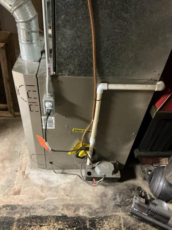 Responded to service call for residential air conditioning system blowing warm air with non-operational condenser fan. Upon inspection of basement-located Carrier HVAC system, evaluated complete forced-air heating and cooling unit including furnace cabinet, air handler, metal ductwork, and refrigerant line configuration. Assessed system components including electrical connections, condensate drain lines, and overall installation integrity to determine equipment viability and provide comprehensive replacement estimate for failed cooling system.