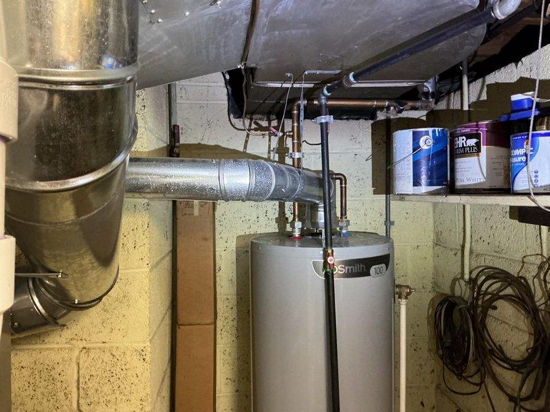 Responded to City of Grosse Pointe Woods code violation regarding improper water heater vent connection slope. Upon inspection, confirmed the hot water tank vent pipe was sloped in the incorrect direction, failing to meet minimum code requirements of 1/4 inch per foot pitch. Disconnected and repositioned the vent connection to ensure proper upward slope away from the A.O. Smith water heater, allowing condensation to drain back toward the appliance and exhaust gases to vent efficiently. Verified correct pitch using level and secured all connections. System tested and brought into compliance with municipal plumbing codes.